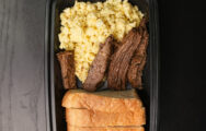 Steak and Eggs on a Dark Table